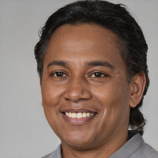 Joyful black adult male with short  brown hair and brown eyes