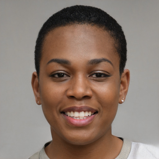 Joyful black young-adult female with short  black hair and brown eyes