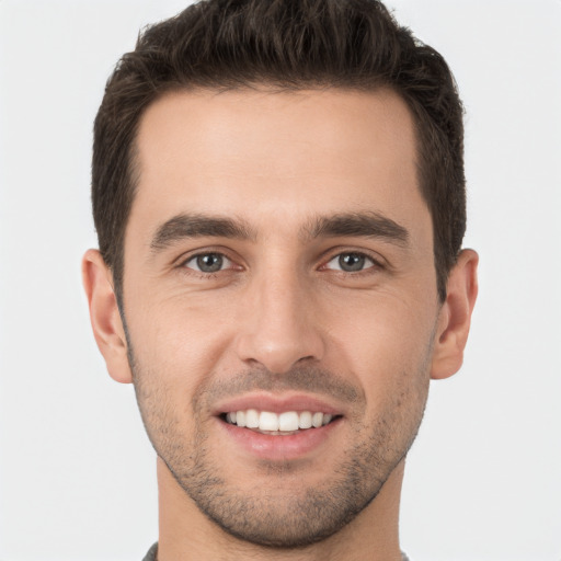 Joyful white young-adult male with short  brown hair and brown eyes