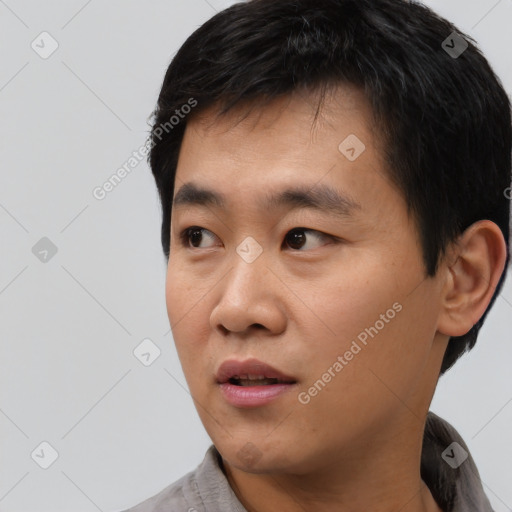 Neutral asian young-adult male with short  black hair and brown eyes