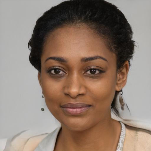 Joyful black young-adult female with short  brown hair and brown eyes