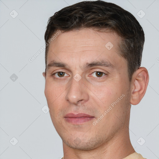 Joyful white adult male with short  brown hair and brown eyes