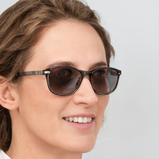 Joyful white young-adult female with medium  brown hair and blue eyes