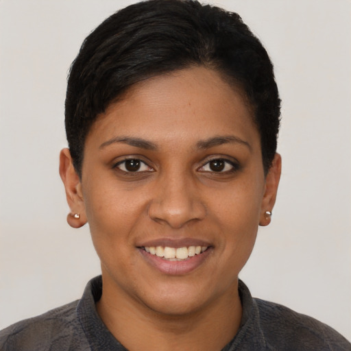 Joyful latino young-adult female with short  black hair and brown eyes