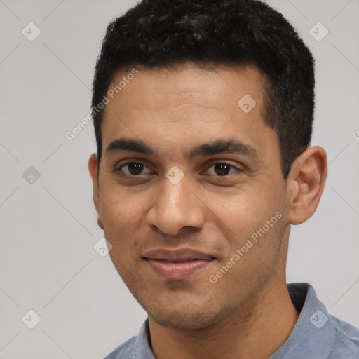 Joyful latino young-adult male with short  black hair and brown eyes