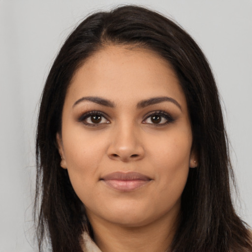 Joyful latino young-adult female with long  brown hair and brown eyes