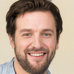 Joyful white adult male with short  brown hair and brown eyes