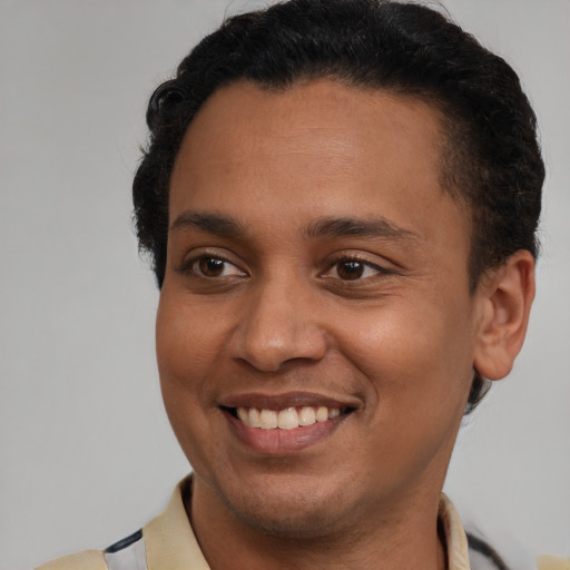 Joyful latino young-adult male with short  brown hair and brown eyes
