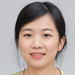 Joyful asian young-adult female with medium  black hair and brown eyes