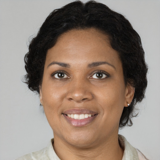 Joyful black adult female with short  brown hair and brown eyes