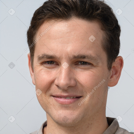 Joyful white adult male with short  brown hair and brown eyes