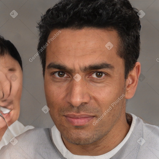 Joyful white adult male with short  brown hair and brown eyes