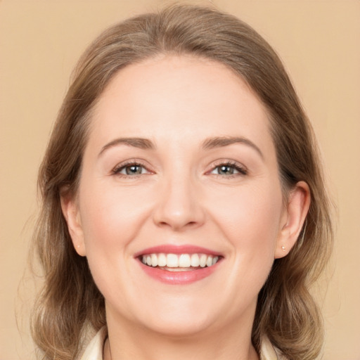 Joyful white young-adult female with medium  brown hair and grey eyes