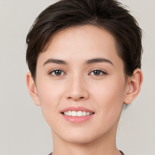 Joyful white young-adult female with short  brown hair and brown eyes