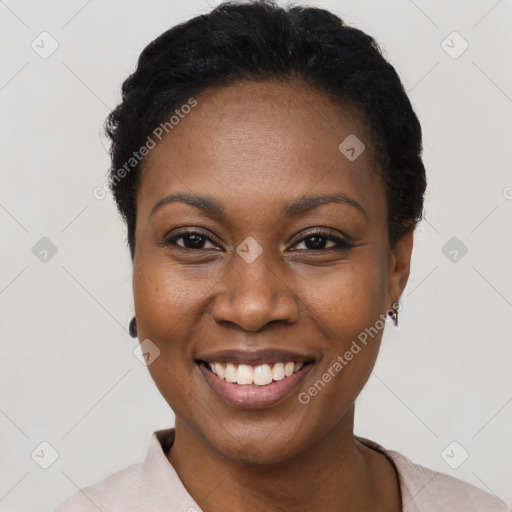 Joyful black young-adult female with short  black hair and brown eyes