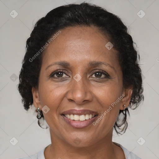 Joyful black adult female with medium  brown hair and brown eyes