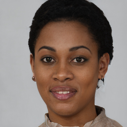 Joyful black young-adult female with short  black hair and brown eyes