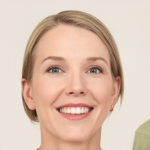 Joyful white young-adult female with medium  brown hair and green eyes