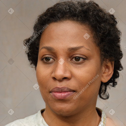 Joyful black adult female with short  brown hair and brown eyes