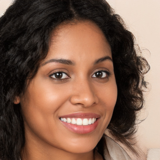 Joyful latino young-adult female with long  brown hair and brown eyes