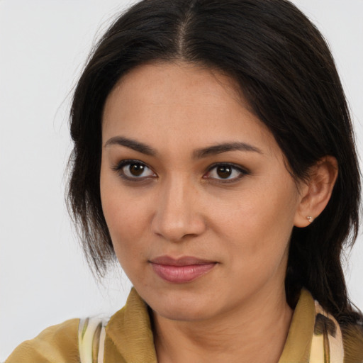 Joyful latino young-adult female with long  brown hair and brown eyes