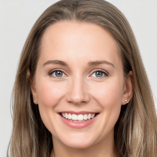 Joyful white young-adult female with long  brown hair and grey eyes