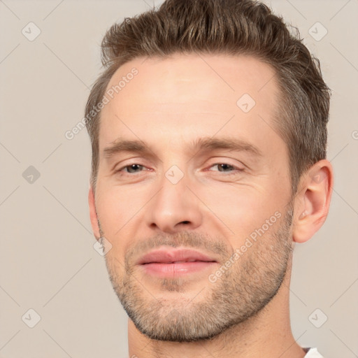 Joyful white adult male with short  brown hair and brown eyes