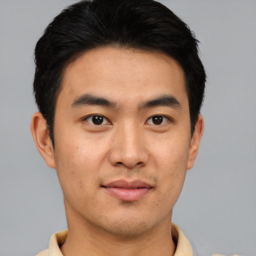 Joyful asian young-adult male with short  black hair and brown eyes