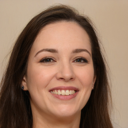 Joyful white young-adult female with long  brown hair and brown eyes