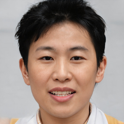 Joyful asian young-adult female with short  brown hair and brown eyes