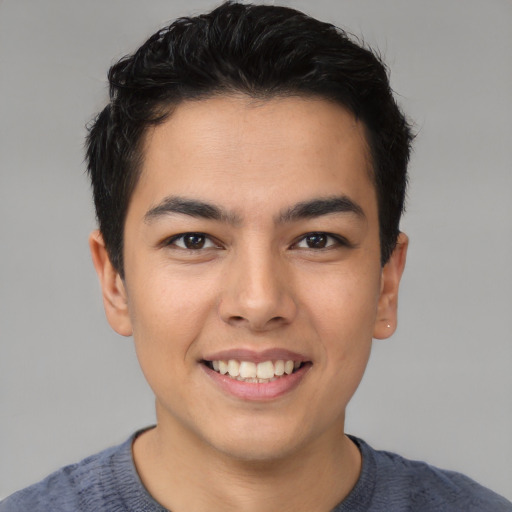 Joyful asian young-adult male with short  black hair and brown eyes