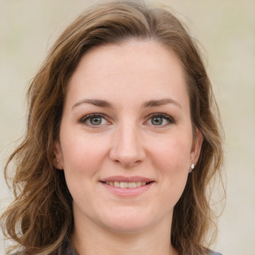 Joyful white young-adult female with medium  brown hair and green eyes