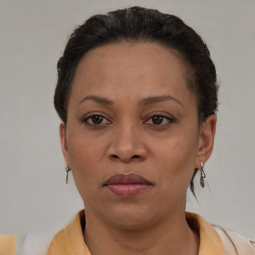 Joyful black adult female with short  brown hair and brown eyes
