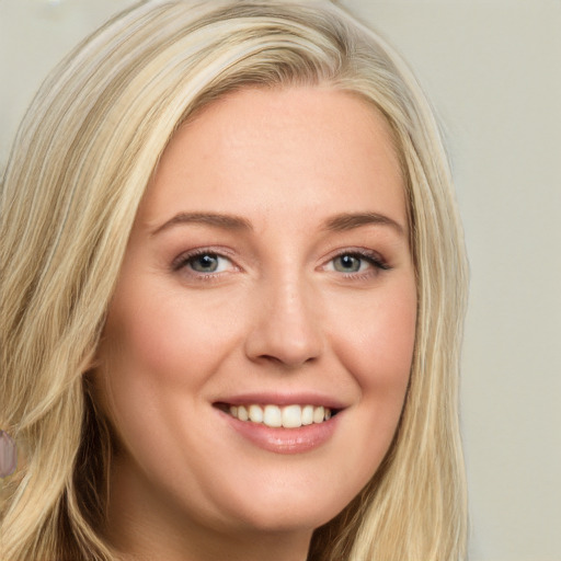 Joyful white young-adult female with long  blond hair and brown eyes