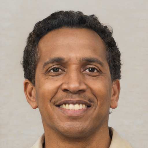 Joyful latino adult male with short  brown hair and brown eyes