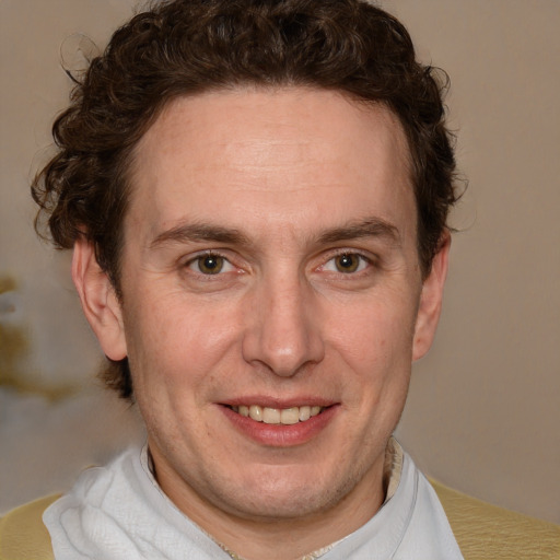 Joyful white adult male with short  brown hair and blue eyes