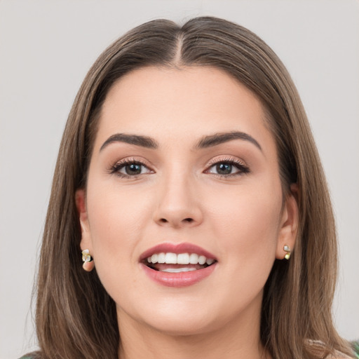 Joyful white young-adult female with long  brown hair and grey eyes