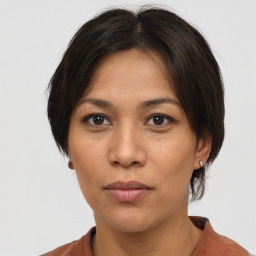 Neutral asian young-adult female with medium  brown hair and brown eyes