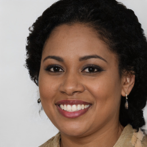 Joyful black young-adult female with long  brown hair and brown eyes