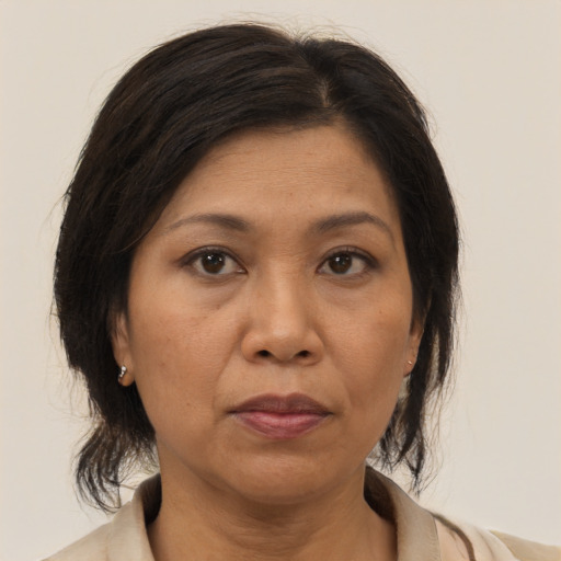 Joyful asian adult female with medium  brown hair and brown eyes