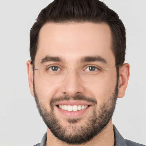 Joyful white young-adult male with short  black hair and brown eyes