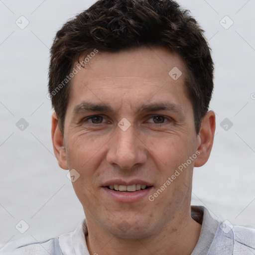 Joyful white adult male with short  brown hair and brown eyes