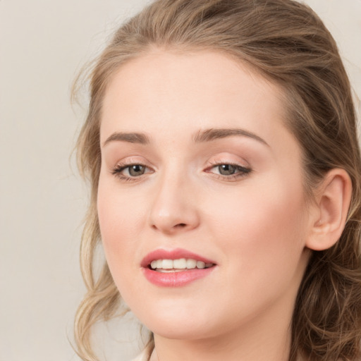 Joyful white young-adult female with long  brown hair and grey eyes