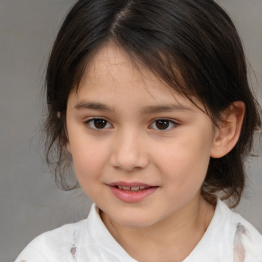 Joyful white child female with medium  brown hair and brown eyes