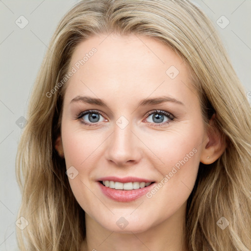 Joyful white young-adult female with long  brown hair and blue eyes