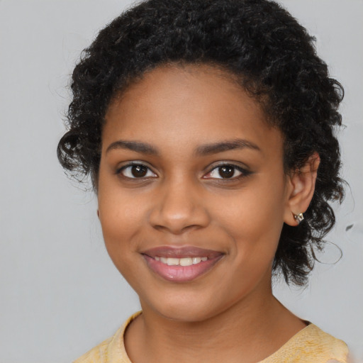Joyful black young-adult female with medium  black hair and brown eyes