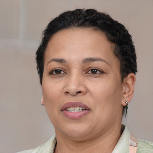 Joyful latino adult female with short  brown hair and brown eyes