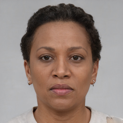 Neutral latino adult female with short  brown hair and brown eyes