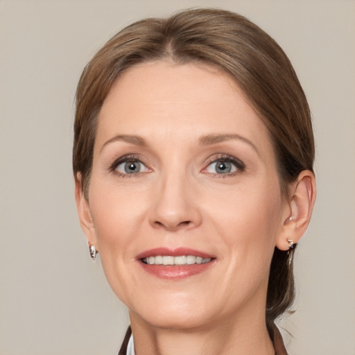 Joyful white adult female with medium  brown hair and grey eyes