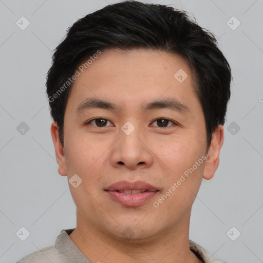 Joyful asian young-adult male with short  brown hair and brown eyes